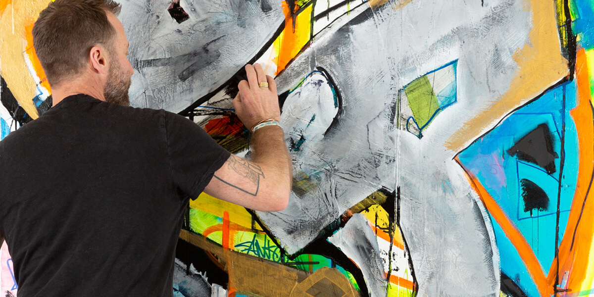 Photo of Chad M. Lawson working on one of his paintings