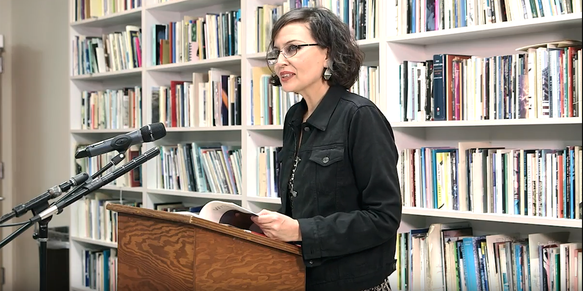 Photo of Layli Long-Soldier speaking at lectern at The Poetry Center