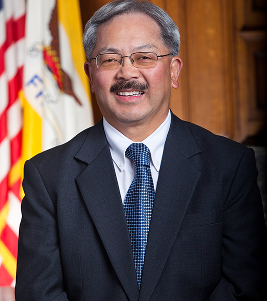 Photo of Mayor Ed Lee standing in front of U.S. and California flags