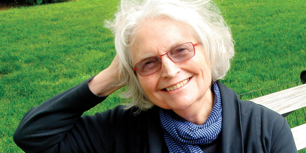 Betty Medsger sitting on a park bench and smiling