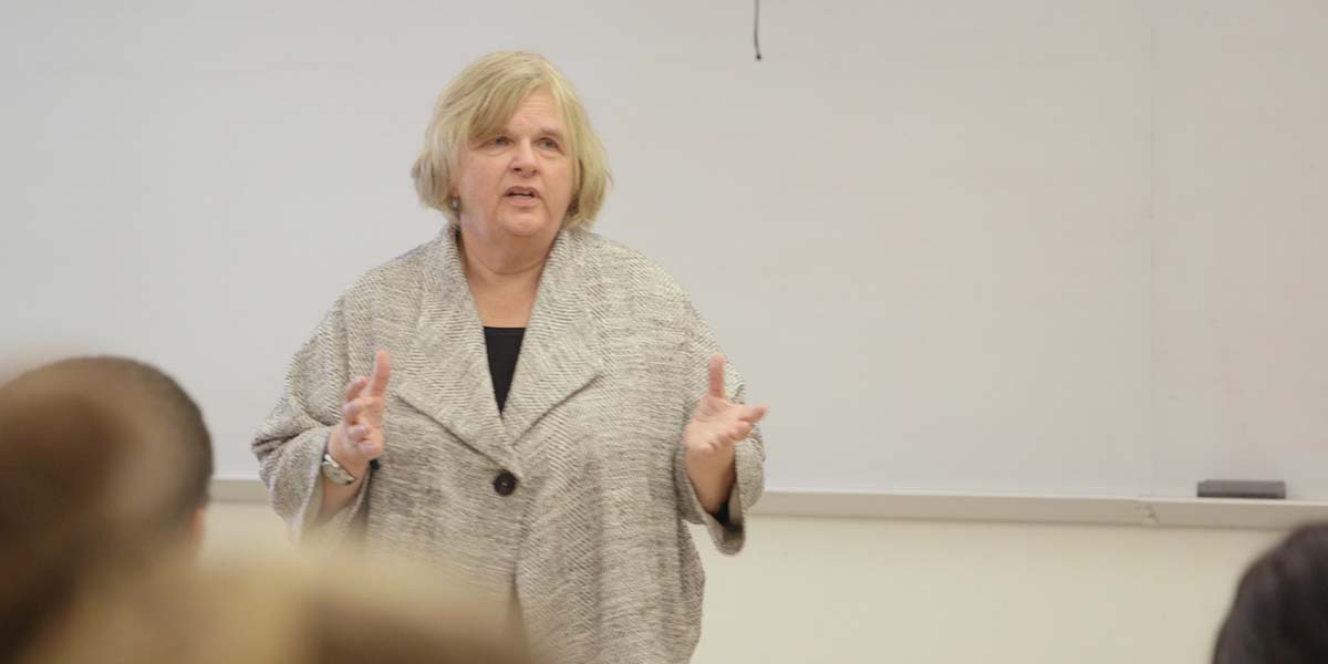 Photo of Kitty Millet lecturing in class