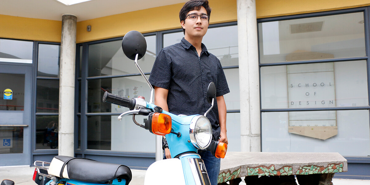 Photo of Anucha Poh Maga standing next to his Honda Super Cub motorcycle