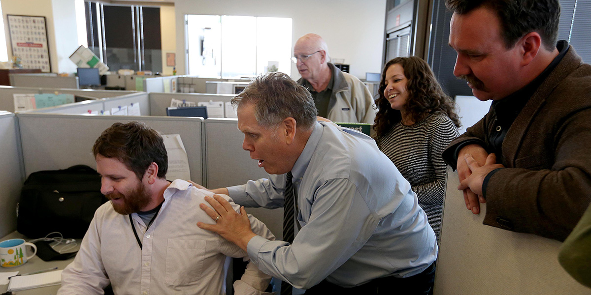 Photo of East Bay Times journalists in newsroom reacting to Pulitzer Prize announcement