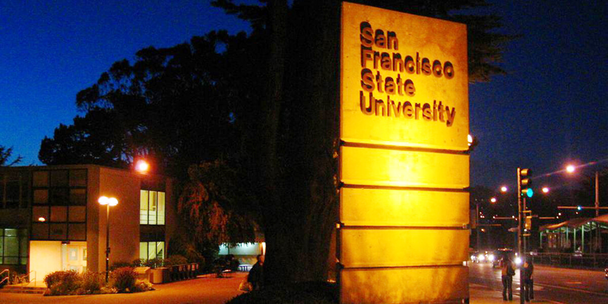 Photo of the 19th Avenue gate on San Francisco State University campus at night