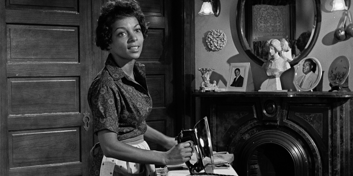 Black and white still of Ruby Dee ironing clothing in A Raisin in the Sun