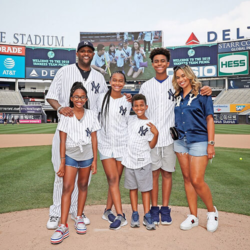 CC Sabathia, Amber Sabathia and their four children on the field at Yankee Stadium