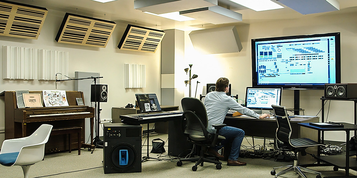 Photo of Professor Benjamin Sabey working in electronic music studio