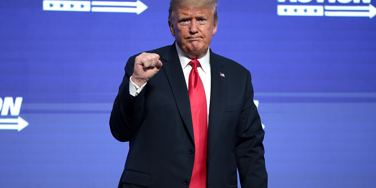 Photo of Donald Trump raising his fist and grimacing during speech in Phoenix