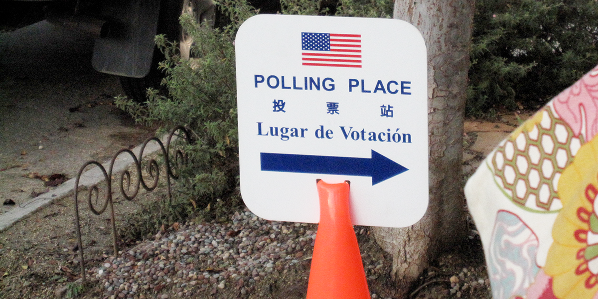 Photo of sign showing directions to polling place in English, Chinese and Spanish