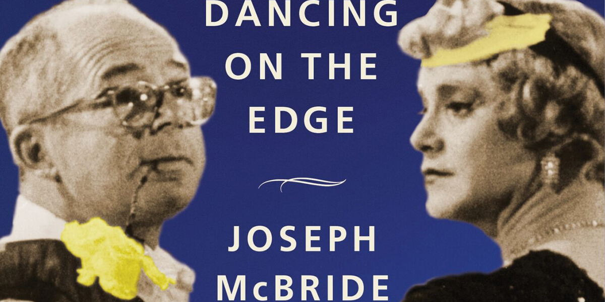 A flower hangs from Billy Wilder's mouth next to Jack Lemmon in drag on the book cover of Billy Wilder: Dancing on the Edge by Joseph McBride