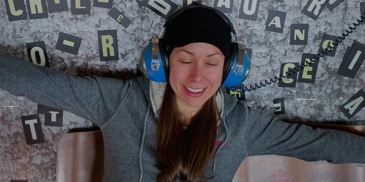 Photo of Holly Bowling enjoying music on blue headphones