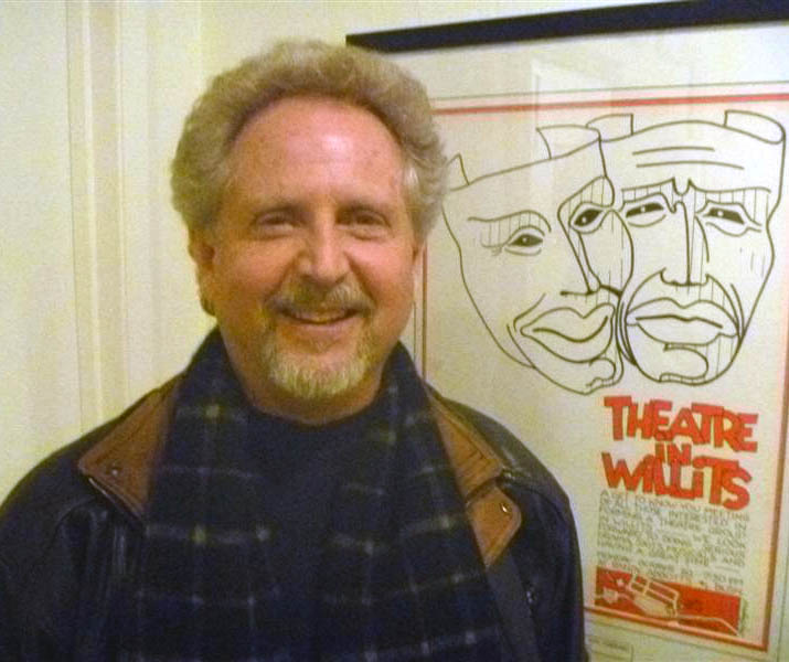 Photo of Steve Hellman by a Theatre in Willits poster