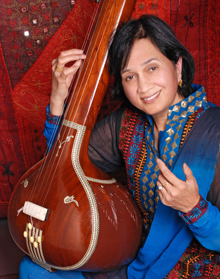 Photo of Rita Sahai holding instrument