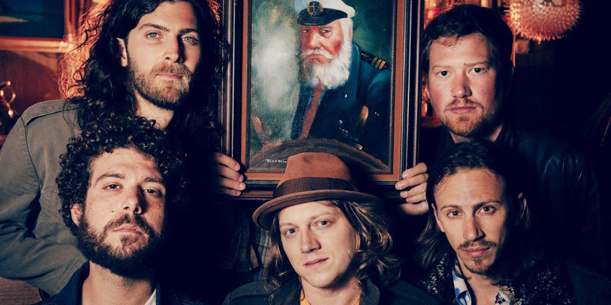 Photo of The Stone Foxes quintet holding a painting of Captain Ahab