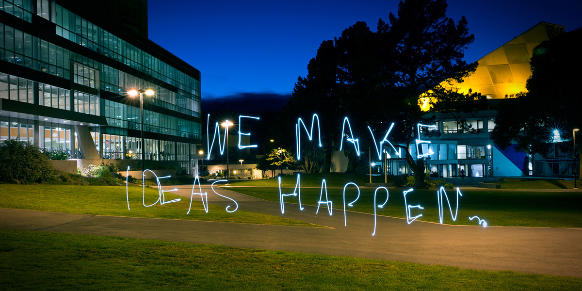 Photo of campus quad with We Make Ideas Happen handwritten