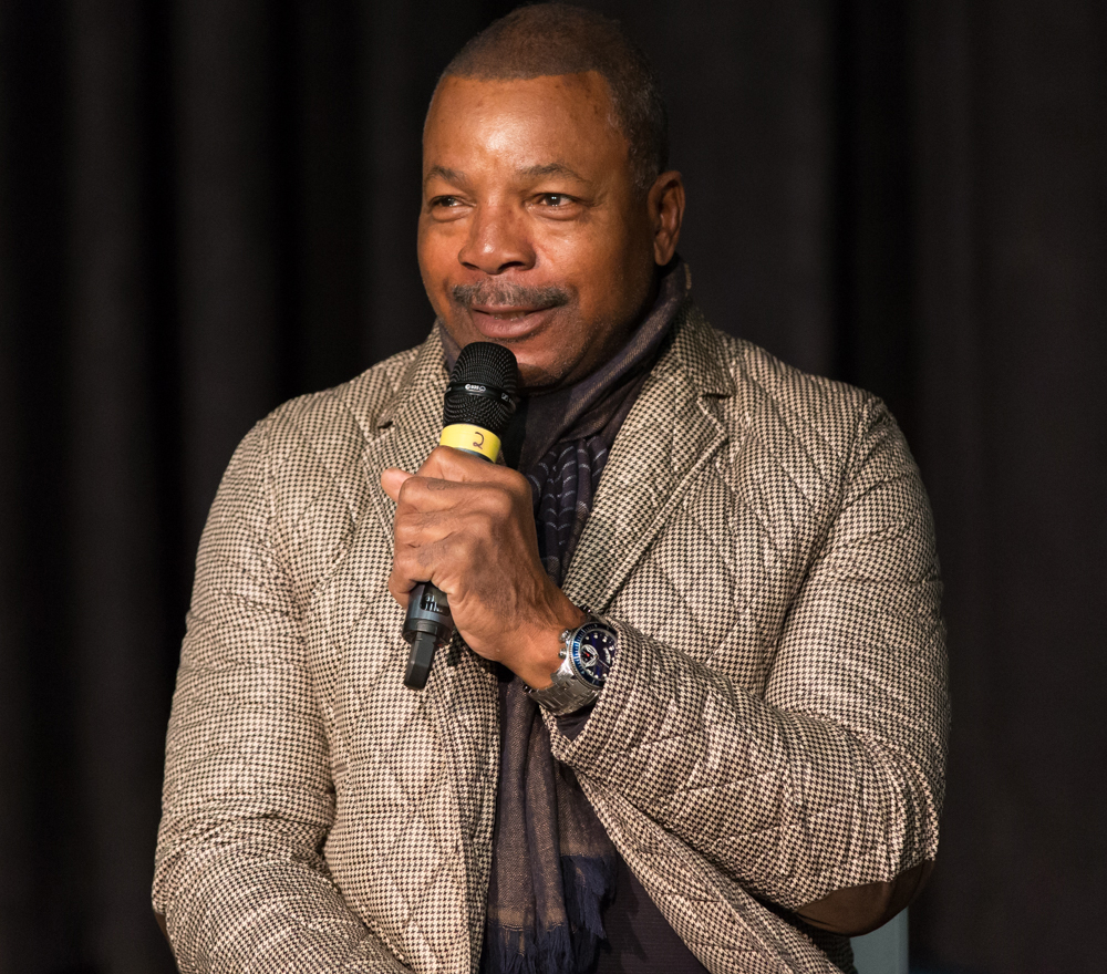 Photo of Carl Weathers holding microphone