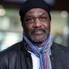 Delroy Lindo wearing a jacket, scarf and hat