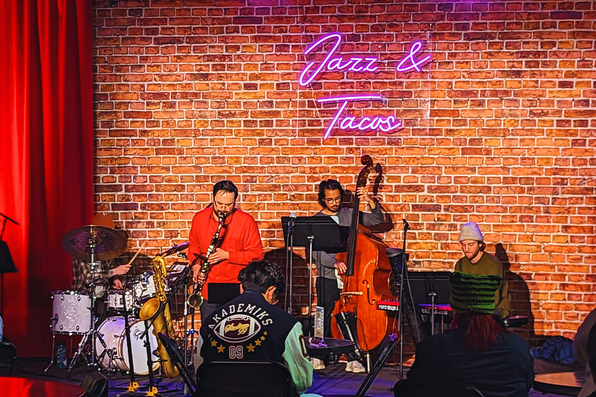 jazz band performing in front of a brick wall