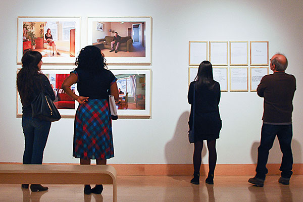 Gallery visitors viewing art work on walls