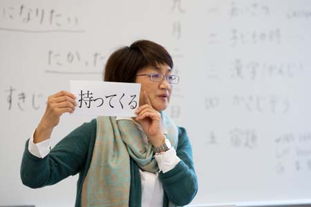 Person holding up a card with mandarin characters