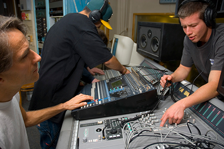 Students operating production control board