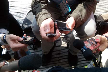 Detail of people holding recording devices