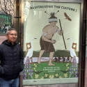 Marcelo Potosi stands on Market Street next to his Revitalizing the Culture poster for the series titled The Future of the Ramaytush Ohlone