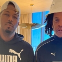 Michael J. Payton and Jay-Z stand next to each other indoors