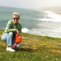 Toni Mirosevich kneels on Mori Point south of the Pacifica Municipal Pier and beach