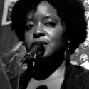 B&W photo of Tonya Foster in front of a mic