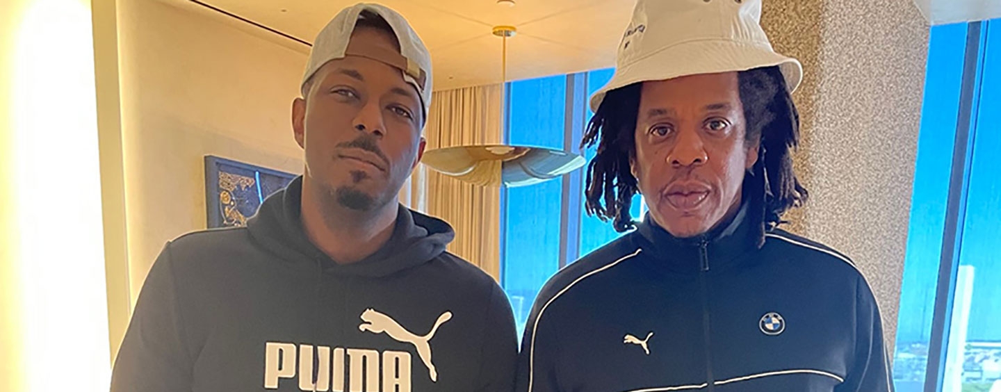 Michael J. Payton and Jay-Z stand next to each other indoors