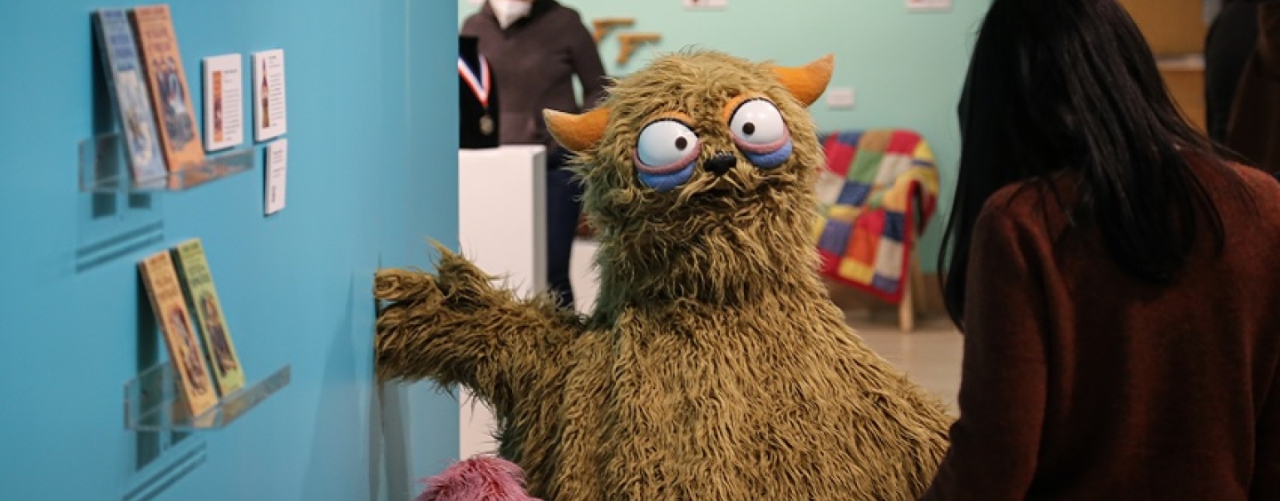 Harry and Gertrude, puppets created by "Sesame Street" performer Michael Earl, welcome a visitor to the Show & Tell exhibit in the Global Museum