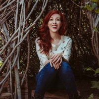 Red haired Ward sitting inside entwined tree branches looking like a hut
