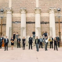 Musicians posed in front of roman columns