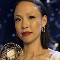 Poh Si Teng holds her Emmy Award statuette while standing at the awards ceremony