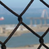 View of SF Bay and Hunter's Point through a chain fence