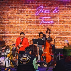 jazz band performing in front of a brick wall