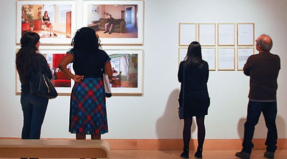 Gallery visitors viewing art work on walls